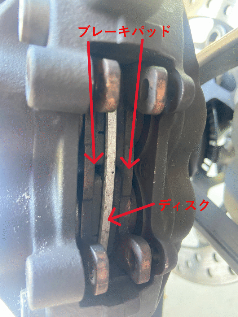 A top-down photo of a brake caliper with the spring pad removed
