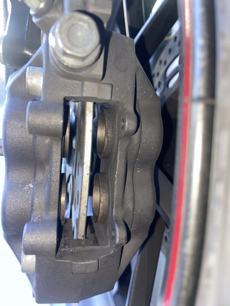 A brake caliper after removing the brake pads