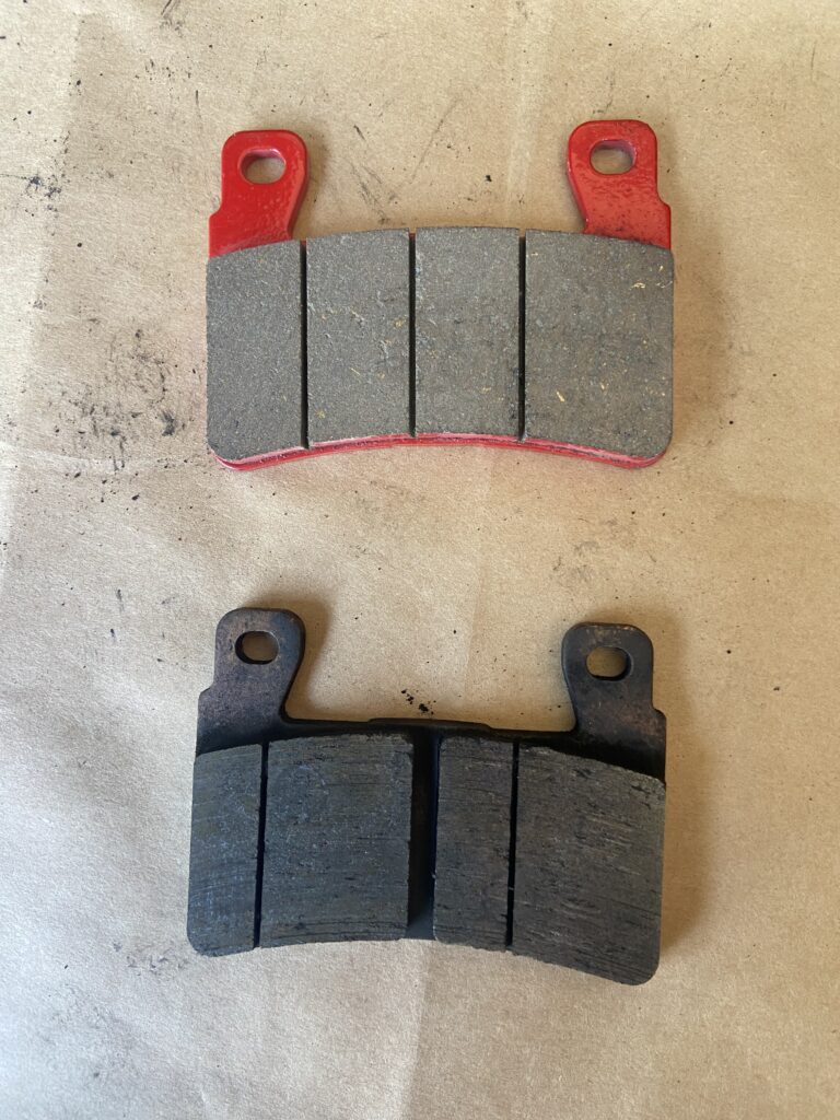 Comparison photo of a new and worn brake pad