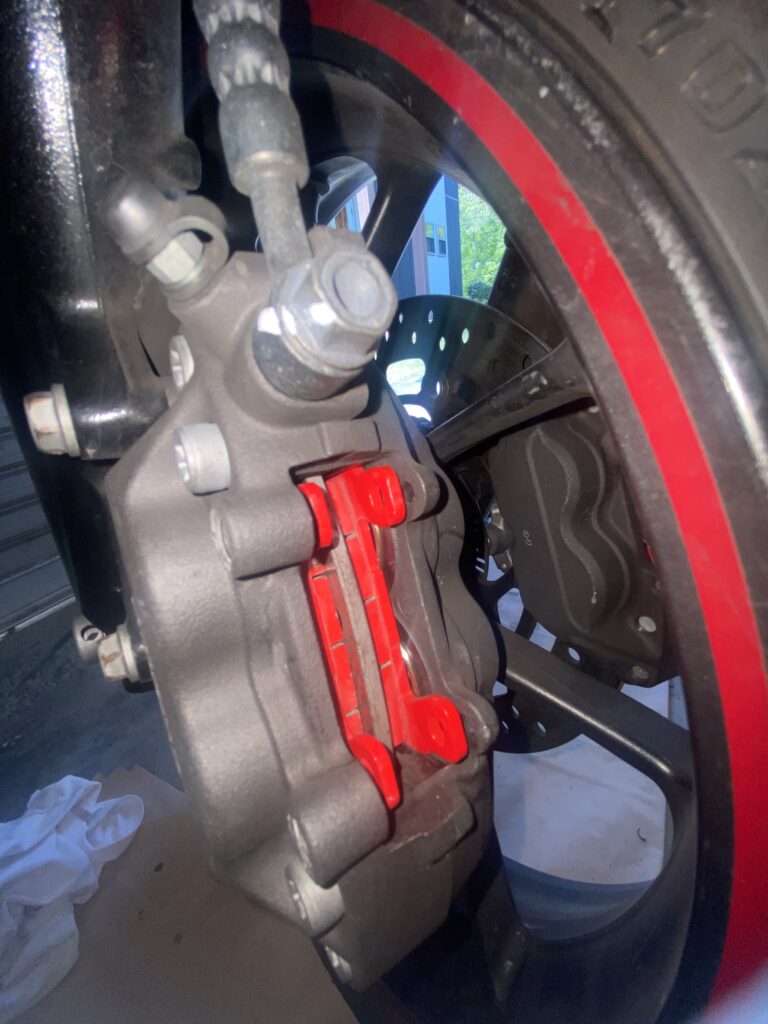 Photo of a brake caliper fitted with new brake pads
